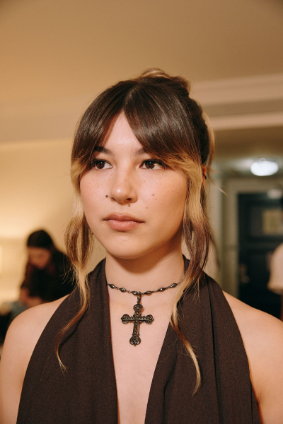 Alysa Liu wearing a black halter dress and cross necklace